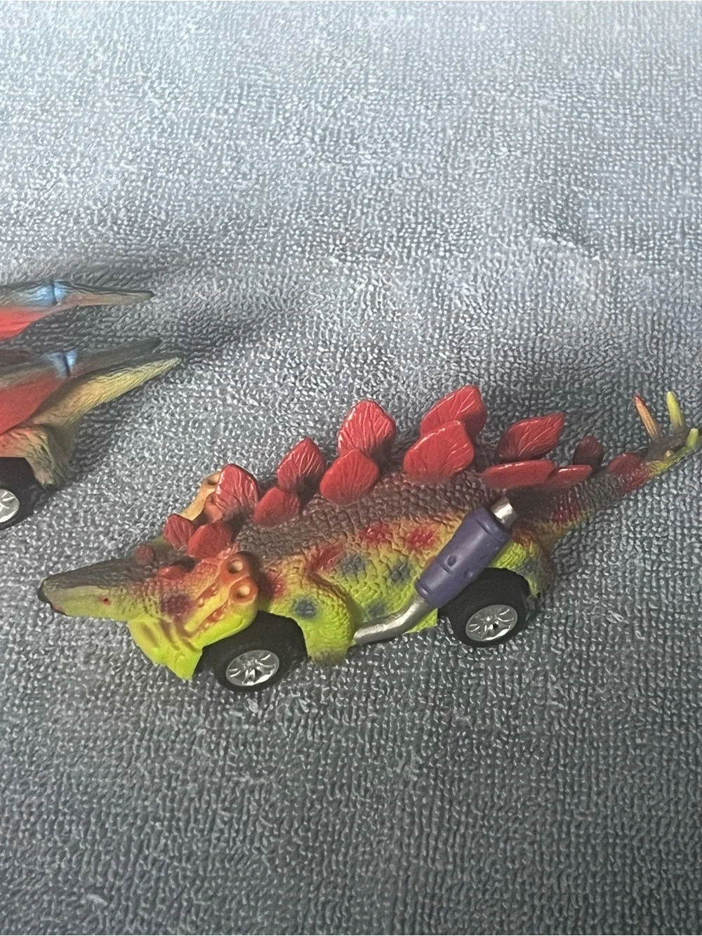 Two dinosaur pull-back toy cars